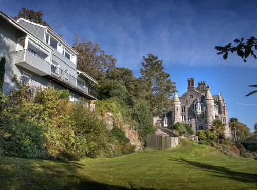 a large house on the side of a hill at Château Rhianfa in Menai Bridge
