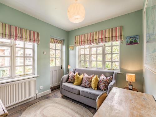 a living room with a couch and windows at Uk44005 - Carters Yard in Kimbolton