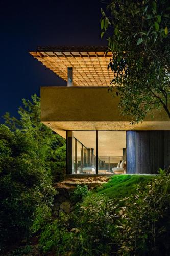 a house on a hill with a roof at 大山初里 Origin Villa Village Hotel&Resort in Tonglu