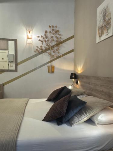 a bedroom with a bed with a potted tree on the wall at Birgu Lodge ground floor with Jacuzzi 0 in Birgu