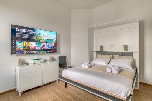 a bedroom with a bed and a large screen at stefanos house in Aliki