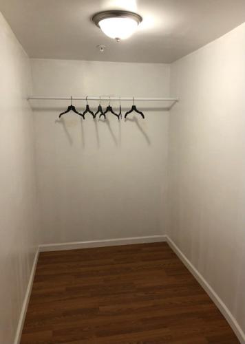 a room with four hangers on a white wall at Large and private apartment that sleeps up to 10 people comfortably with direct NYC Manhattan train only 5 minute walk away in Elizabeth