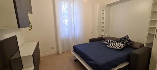 a small room with a bed with pillows on it at Trastevere incantevole con patio esterno privato in Rome
