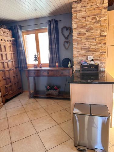 a kitchen with a counter and a table and a window at Le Preyet in Veysonnaz