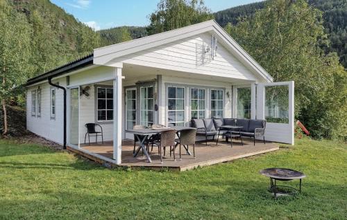 a pavilion with a table and chairs on a deck at 2 Bedroom Nice Home In Skatval in Tilleraune