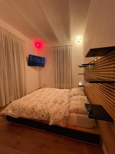 a bedroom with a bed and a tv on the wall at Domus Gaia in Rome