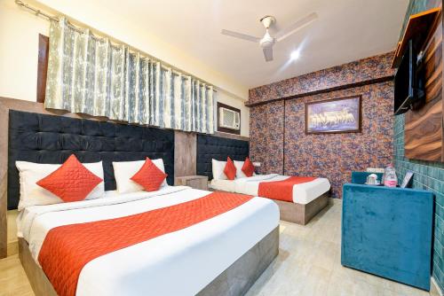 a hotel room with two beds and a television at Airport Hotel Classic Park in New Delhi