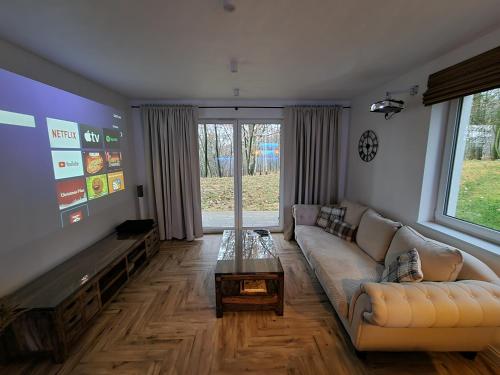a living room with a couch and a table at Apartament Podedworze in Bochnia