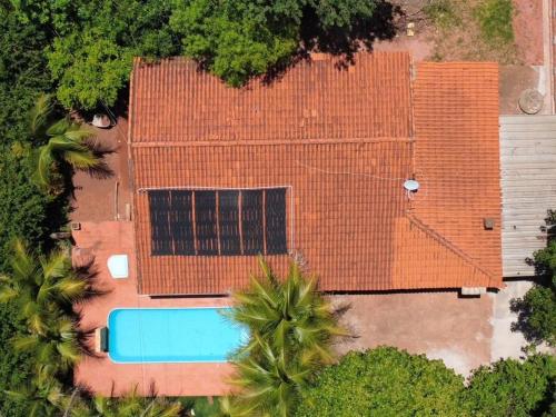 an overhead view of a building with a blue swimming pool at Chácara São Francisco in Olímpia