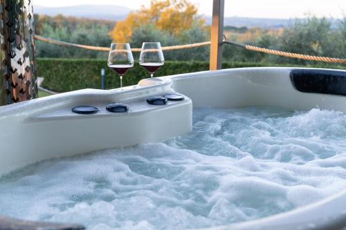 two glasses of wine in a bath tub with snow at Relais CastelBigozzi in Monteriggioni