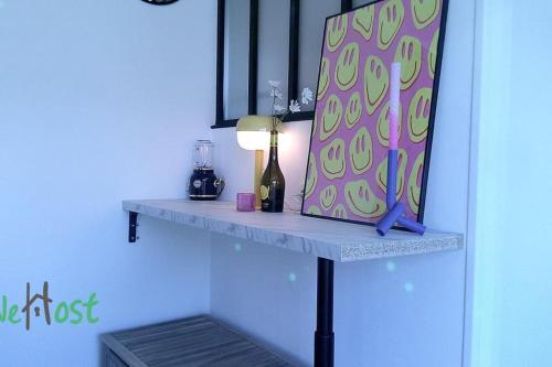 - une étagère avec une bouteille de vin et un miroir dans l'établissement Basse chenaie Cocon avec terrasse et Parking, à Nantes