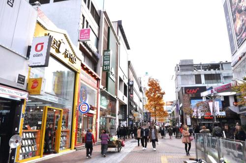 a group of people walking down a busy city street at Daemyeongyeok - house of gallery in Daegu