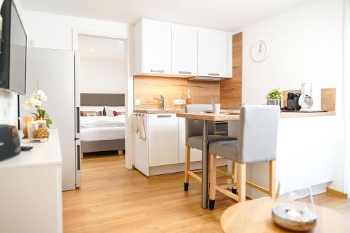 a small kitchen with a table and a room with a bed at Simon´s Ferienwohnungen in Kurort Oberwiesenthal