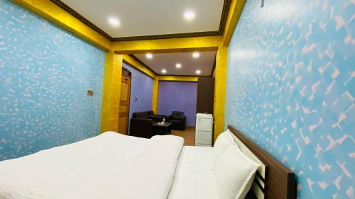 a bedroom with a bed and a couch in a room at SN Guest House in Bhaktapur