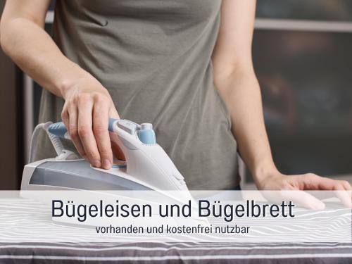 a person is standing next to a appliance with their hand on it at Casa Michaela Öhringen - wunderschöne Aussicht - Top für Familien und Geschäftsreisen, super ausgestattet in Öhringen