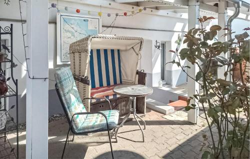 アールベックにあるFerienwohnung Ahlbeck Seebadのポーチ(ロッキングチェア、テーブル付)