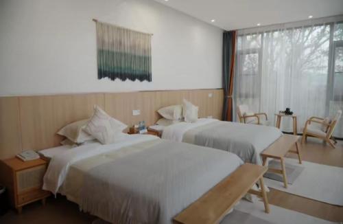 Postel nebo postele na pokoji v ubytování Yuan Meng Town