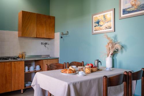 a kitchen with a table with food on it at Club del Sole Stork Family Collection in Giulianova