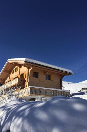 a building with snow in front of it at Apartment Butterfly by Interhome in Adelboden