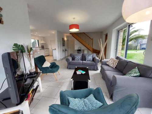 a living room with a couch and chairs and a tv at Holiday Home Golf de Bretagne by Interhome in Sarzeau