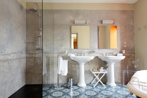 a bathroom with two sinks and a shower at Prosper Maufoux - Château de Saint-Aubin in Saint-Aubin