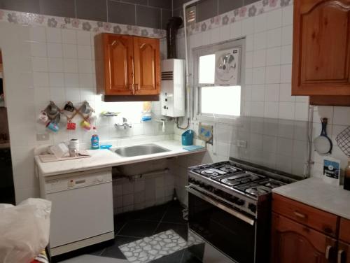 a small kitchen with a sink and a stove at مساكن شيراتون in Cairo