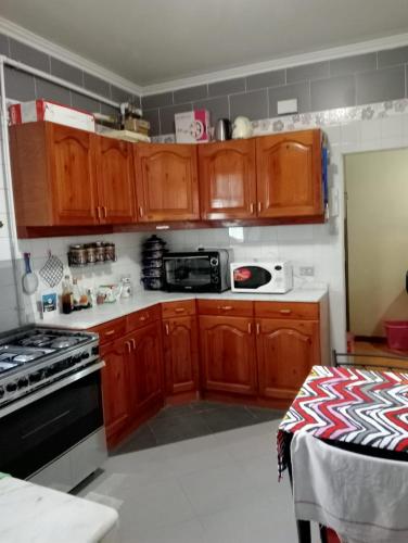 a kitchen with wooden cabinets and a stove top oven at مساكن شيراتون in Cairo