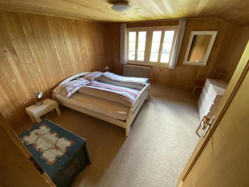 a small bedroom with a bed and a window at Apartment Sonnige Matte by Interhome in Gstaad