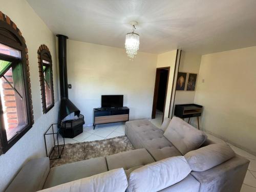 a living room with a couch and a television at Casa em Feliz RS in Feliz