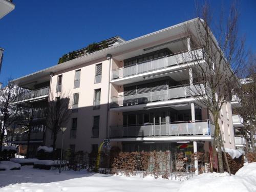 a white building with snow in front of it at Apartment Dorfstrasse 50a by Interhome in Engelberg