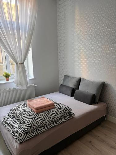 a bedroom with a large bed with a window at Apartament Obotrycka 9C in Gorzów Wielkopolski