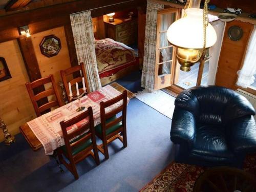 a room with a table and chairs and a bed at Apartment Le Vieux Chalet by Interhome in Gstaad