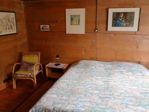 a bedroom with a bed and a chair at Apartment Mittaghorn by Interhome in Gsteig