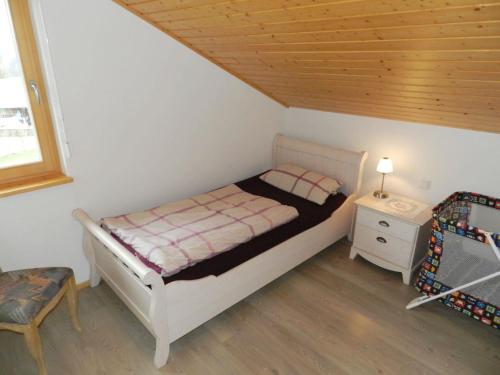 a bedroom with a bed and a table and a chair at Apartment Panorama- Chalet by Interhome in Blankenburg