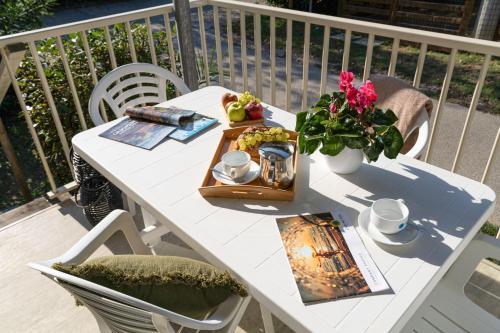 a white table with a tray of food and flowers at Club del Sole Stork Family Collection in Giulianova