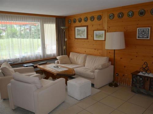 a living room with a couch and a table at Apartment La Sarine 20 by Interhome in Gstaad