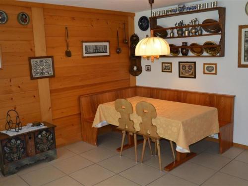 a dining room with a table and two chairs at Apartment La Sarine 20 by Interhome in Gstaad
