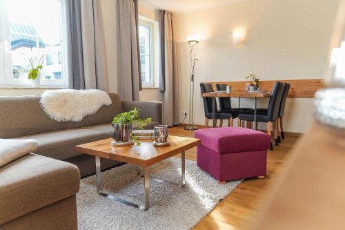 a living room with a couch and a table at Simon´s Ferienwohnungen in Kurort Oberwiesenthal