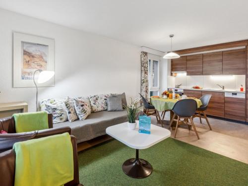 a living room with a couch and a table at Apartment Residence Apt- 15 by Interhome in Wengen