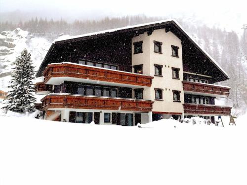 a building in the snow with snow at Apartment Sunshine by Interhome in Saas-Grund
