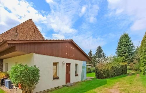 a small white building with a brown roof at Awesome Home In Königs Wusterhausen Ot in Kablow