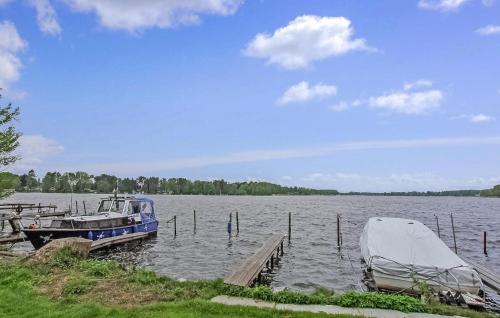 two boats are docked at a dock on a lake at Awesome Home In Königs Wusterhausen Ot in Kablow