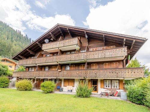 a large building with balconies on the side of it at Apartment Résidence Sonnegg - Herrli by Interhome in Zweisimmen