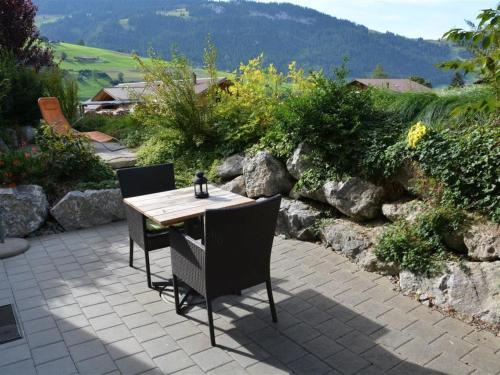 a wooden table and chairs on a patio at Apartment Bolzli-Hus by Interhome in Blankenburg