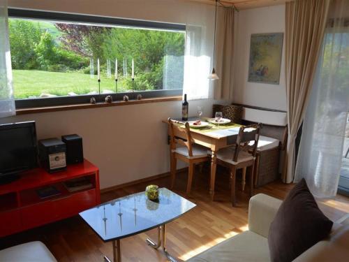 a living room with a table and a dining room at Apartment Bolzli-Hus by Interhome in Blankenburg