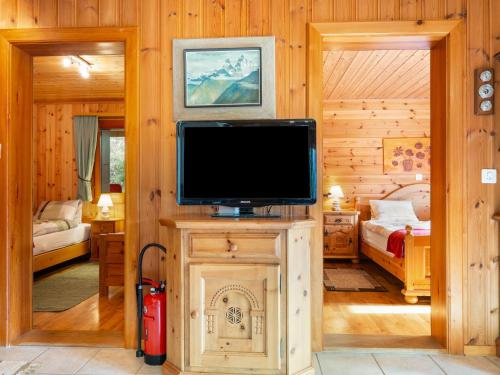 a living room with a television and a bedroom at Chalet Als man zählte 1989 by Interhome in Gasenried