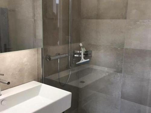 a bathroom with a shower and a sink at Apartment Turmalin 2- Stock by Interhome in Lenk