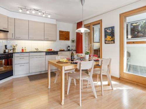 a kitchen with a dining room table and chairs at Apartment Silberhorn Apt- V by Interhome in Wengen