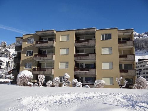 an apartment building in the snow with snow covered trees at Apartment Alpenstrasse 621 by Interhome in Engelberg