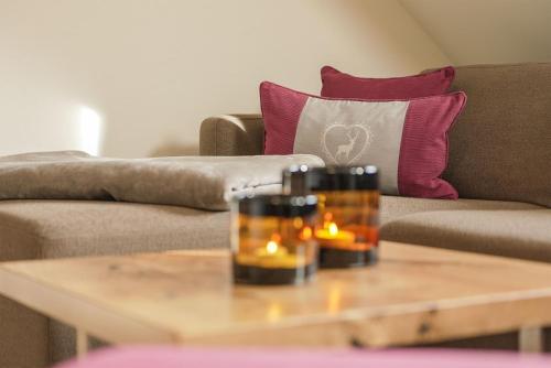 a coffee table in front of a couch with candles on it at Simon´s Ferienwohnungen in Kurort Oberwiesenthal